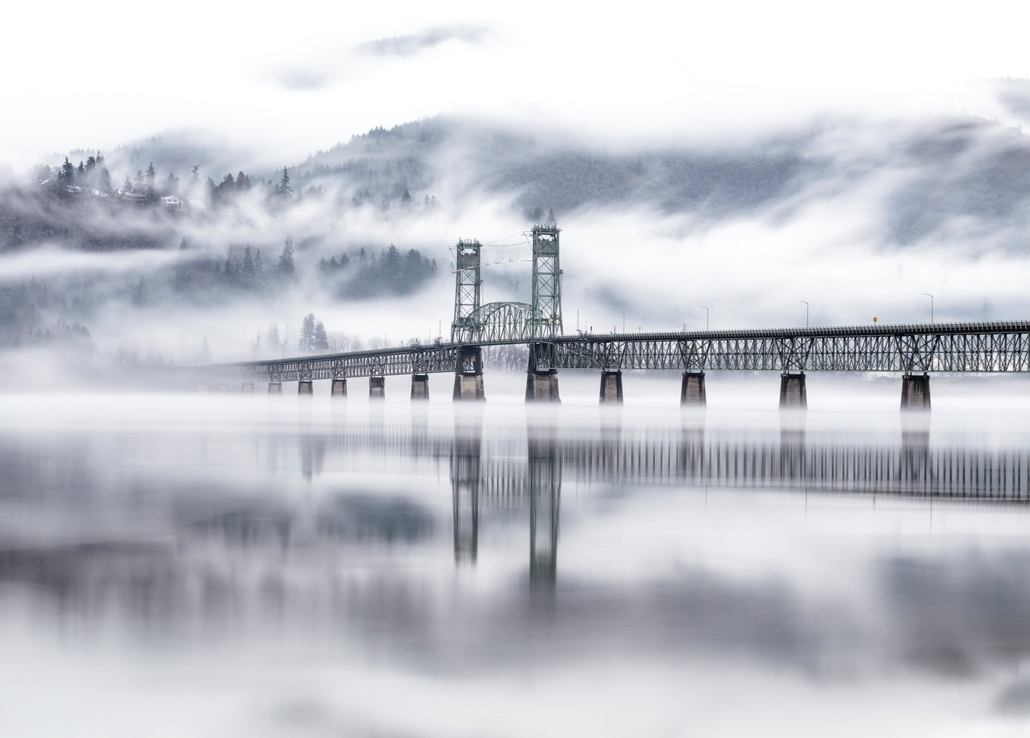 Hood River Bridge emerging from morning fog over the Columbia River Gorge, Oregon 