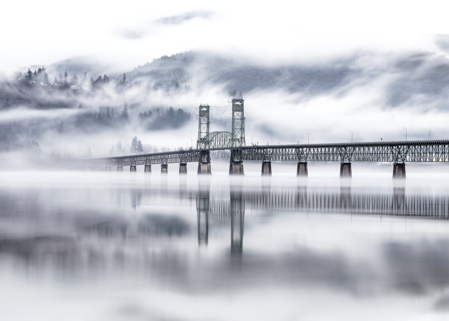 Hood River Bridge emerging from morning fog over the Columbia River Gorge, Oregon 