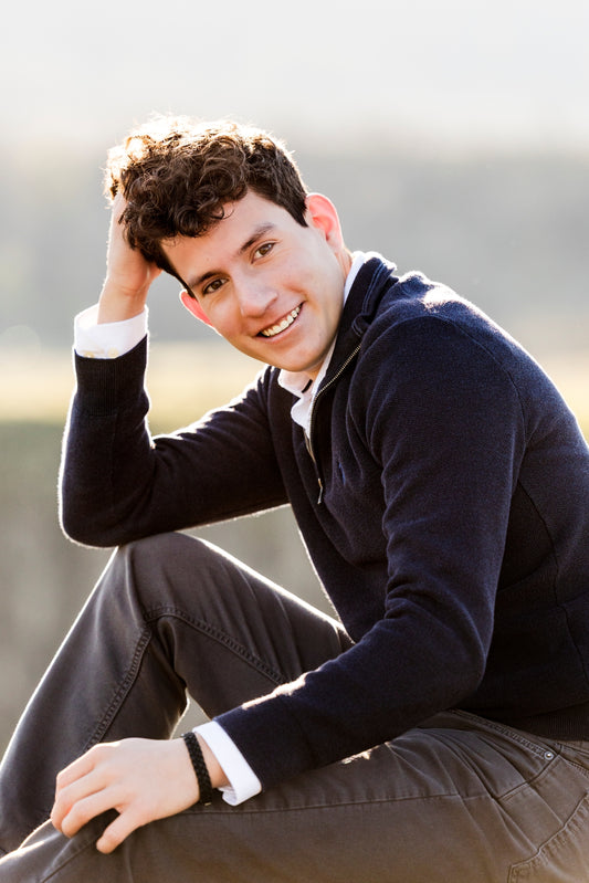 Young Man sitting outdoors with a blurred background.  Senior portrait photography session, Columbia River Gorge Oregon 