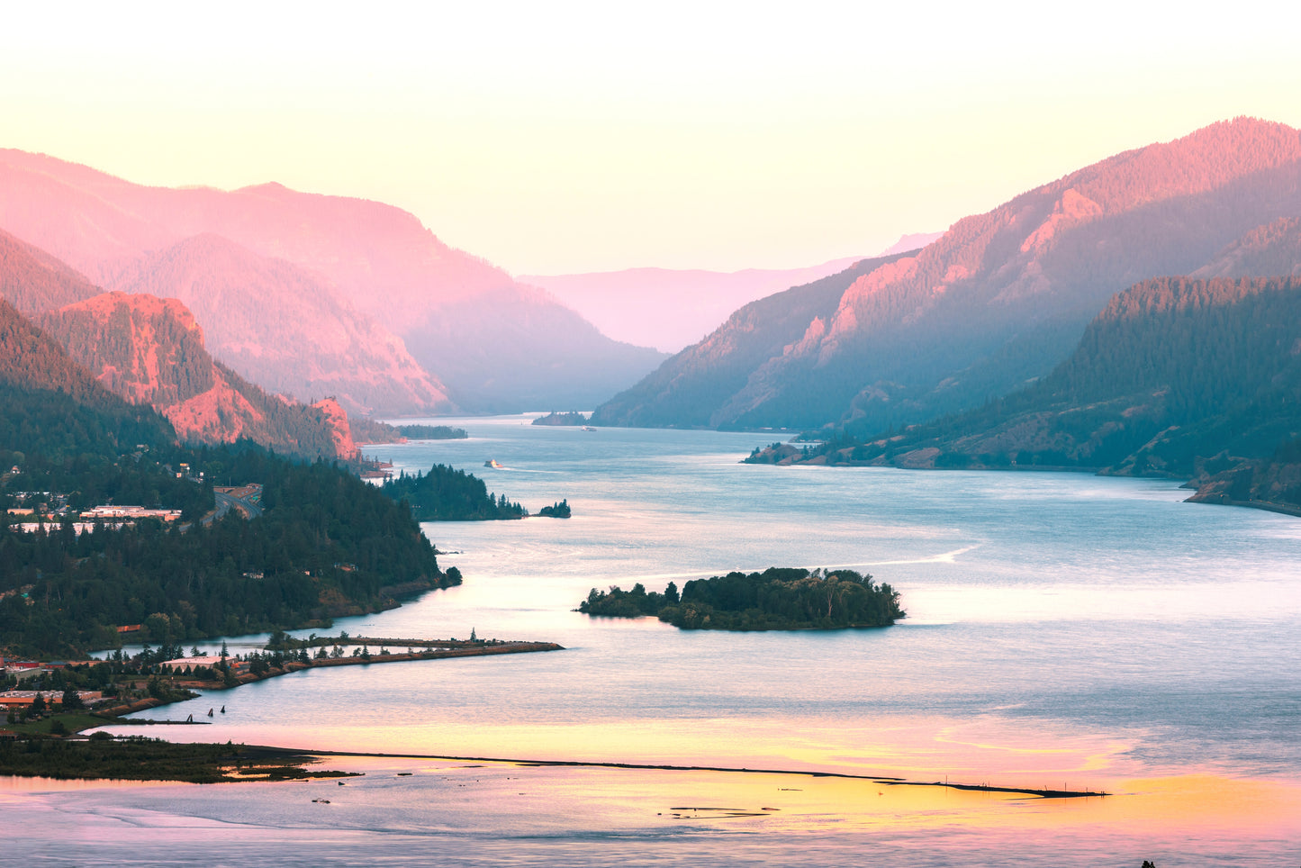 Columbia River Gorge near Hood River, Oregon, captured during a peachy sunrise, revealing the dramatic cliffs of the Gorge.