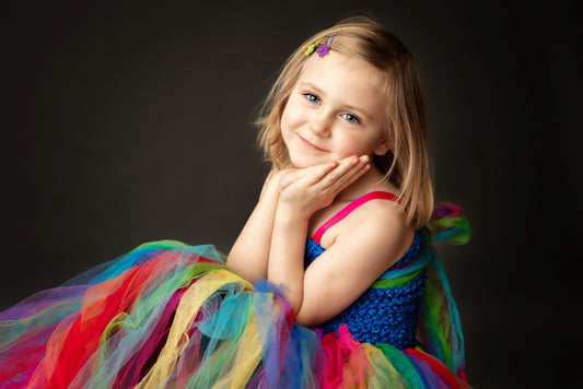 Young girl in a colorful dress posing against a dark background.  Minimalist portrait mini session, Hood River Oregon photographer 