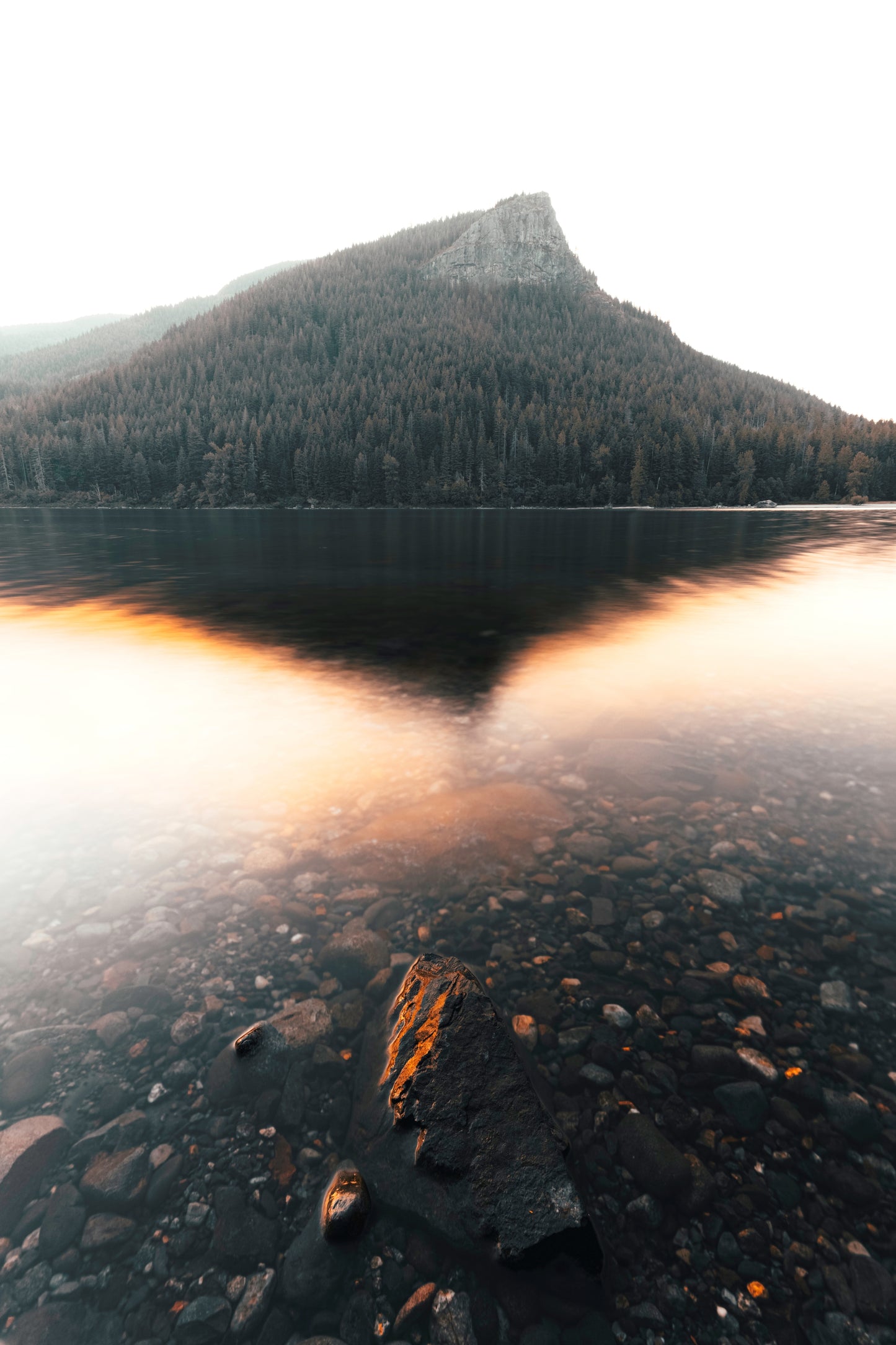 Rattlesnake Lake reflection at sunrise near North Bend Washington, serene mountain lake with mirror-like water reflections and forest silhouettes, Pacific Northwest landscape photography, Cascade Mountains fine art print